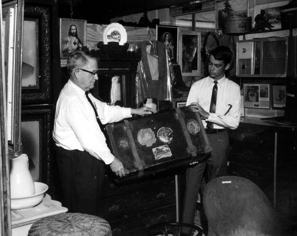 T.T. Wentworth Jr. and a museum staff member holding a piece of luggage - Pensacola, Florida.