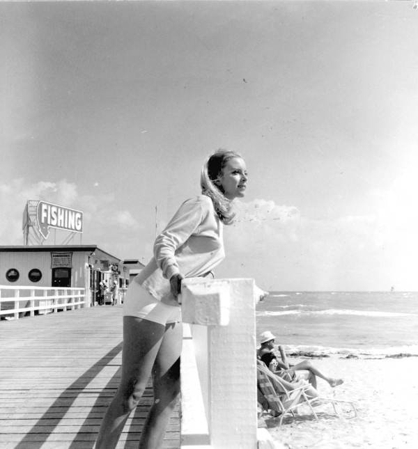 Young woman looking out over a boardwalk