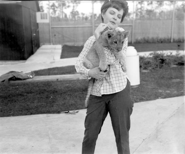 Woman holding lion cub at the Lion Country Safari zoo