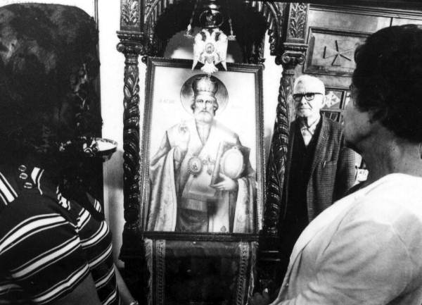 People examining painting of a weeping icon at St. Nicholas Orthodox Church