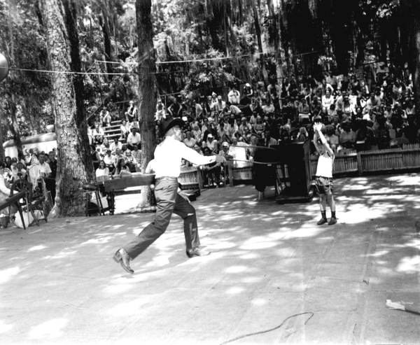 Curly Dekle performs tricks with his whip at the Florida Folk Festival - White Springs, Florida