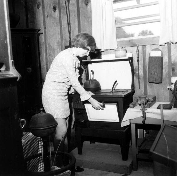 A staff member opening a stove at the Pioneer Park Museum - Zolfo Springs, Florida