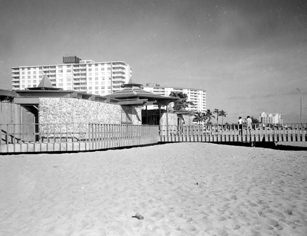 Pompano Beach Pier building with apartment and condominium in beackground - Pompano Beach, Florida.