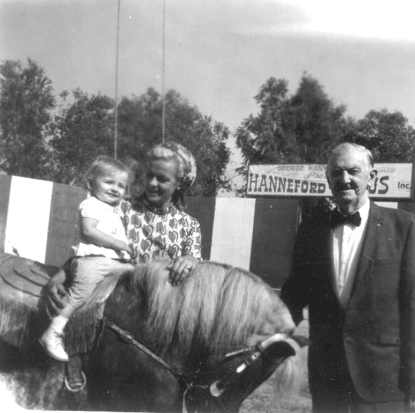 Man and woman standing next to child on horseback- Sarasota, Florida.