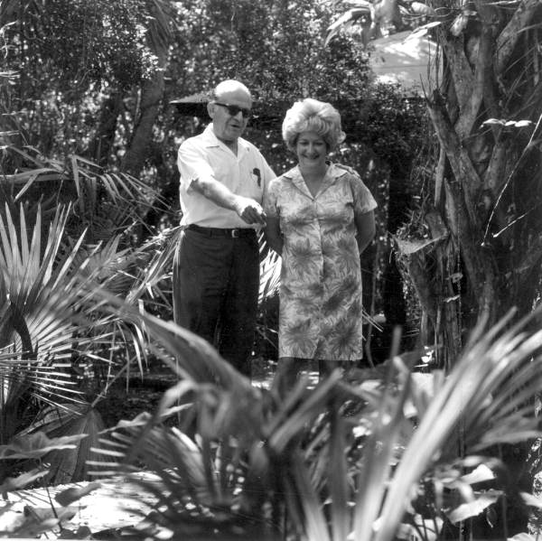 Unidentified man points out plants to a woman - Cocoa Beach, Florida