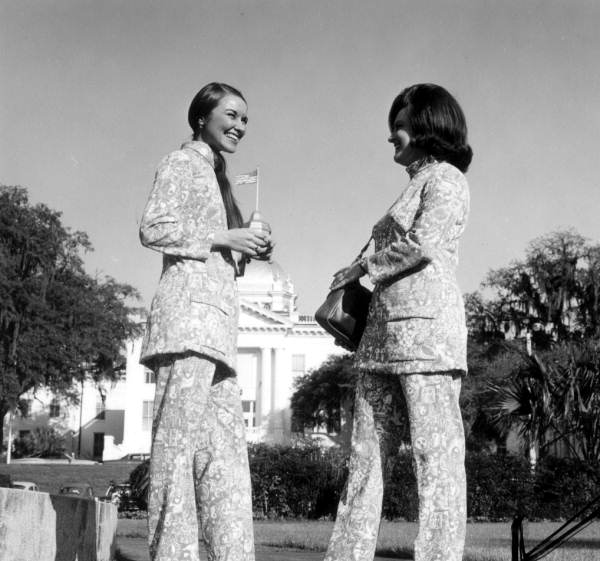 Unidentified women model the new uniforms for the welcome station attendents