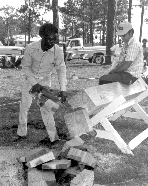Sawing wood at the Florida Forest Festival.