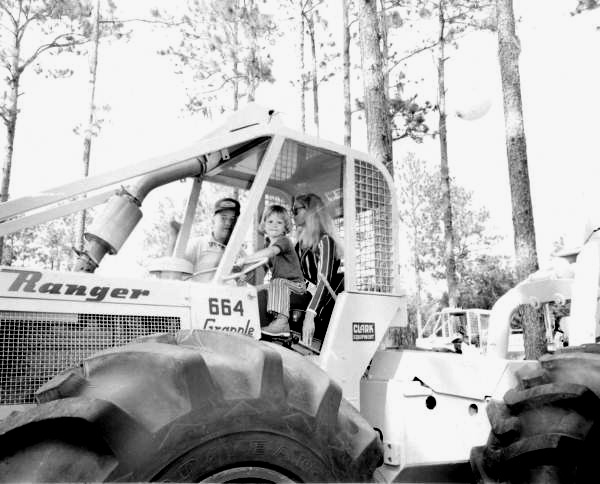 Young child at the wheel of a tractor at the Florida Forest Festival.