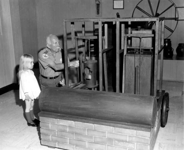 A staff member explains the ice machine to a little girl at the John Gorrie Museum - Apalachicola, Florida.