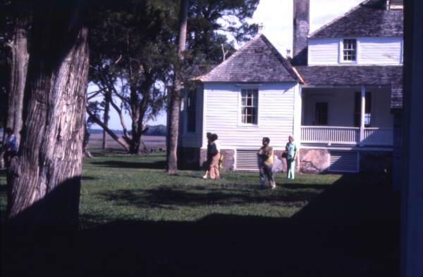 Park visitors in front of the main house at Kingsley Plantation State Historic Site - Fort George Island, Florida.