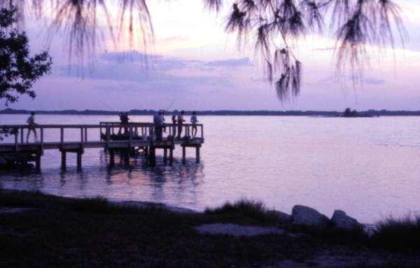 View showing people fishing from a dock at Sebastian Inlet State Park - Melbourne Beach, Florida.