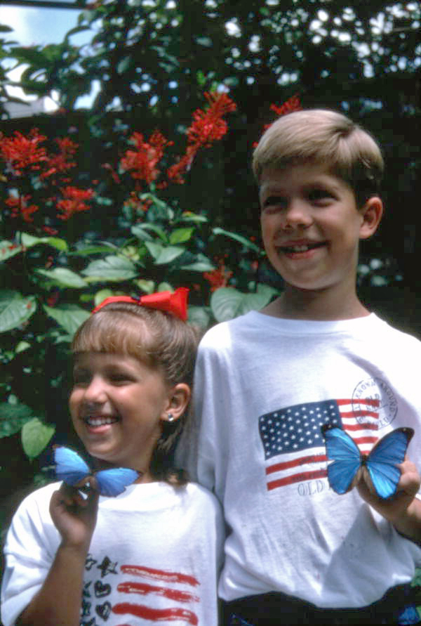 Children with Blue Morpho butterflies at the Butterfly World attraction in Coconut Creek, Florida.