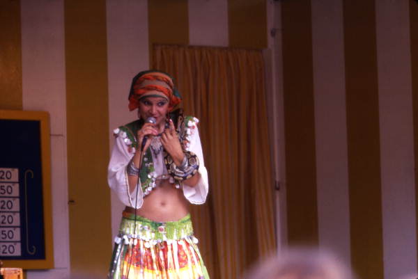 Woman singing while holding a snake during performance at the Busch Gardens amusement park in Tampa, Florida.