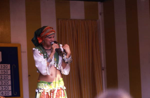 Woman singing while holding a snake during performance at the Busch Gardens amusement park in Tampa, Florida.