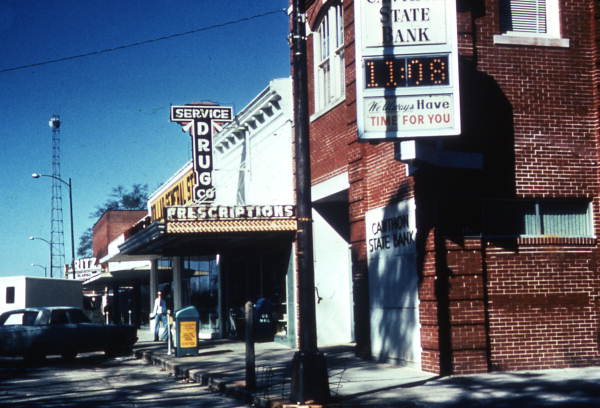 View showing the Cawthon State Bank and Service Drug Company store on Baldwin Avenue in DeFuniak Springs, Florida.