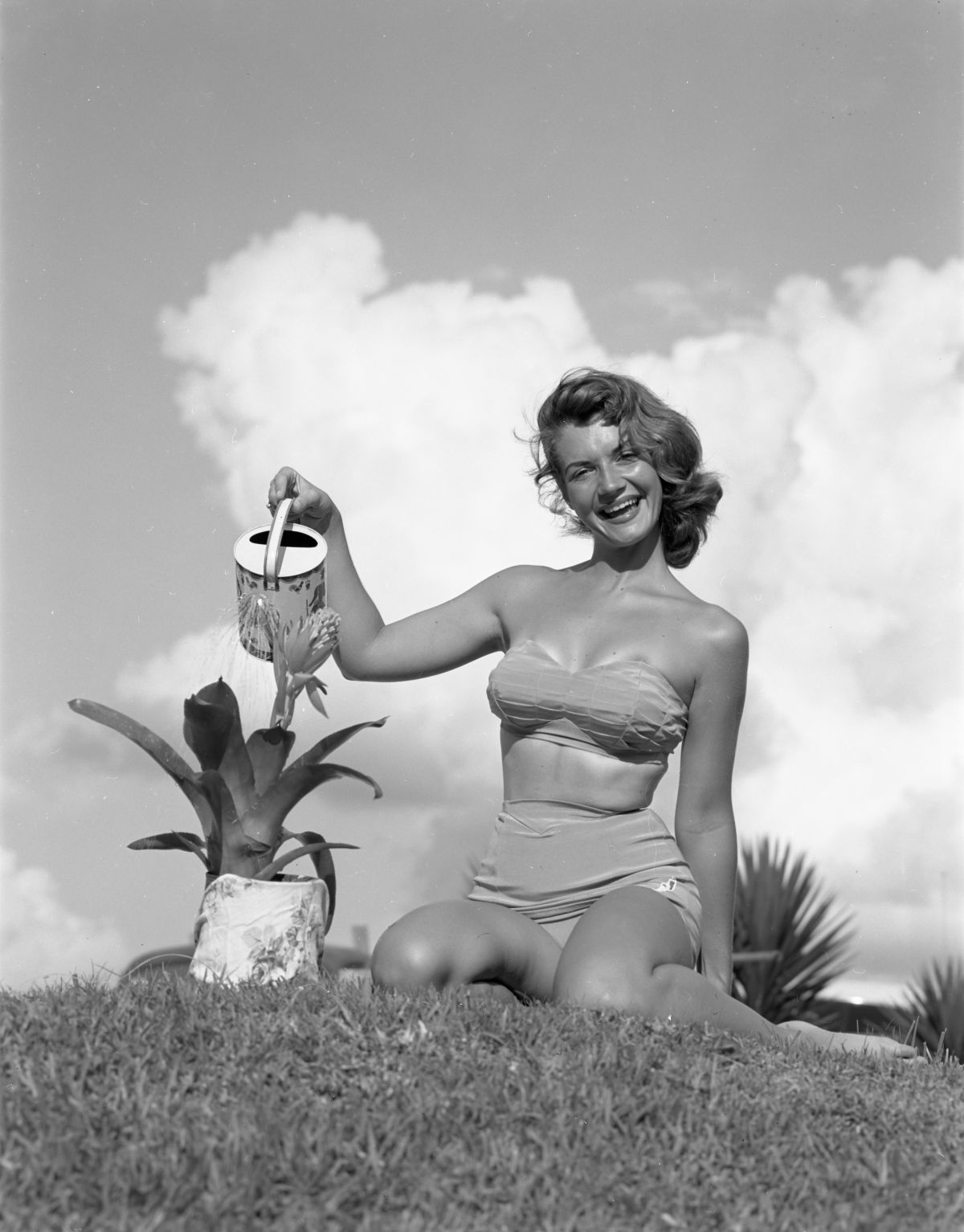 Barbara Laney poses in a bikini watering an air plant - Winter Haven, Florida.