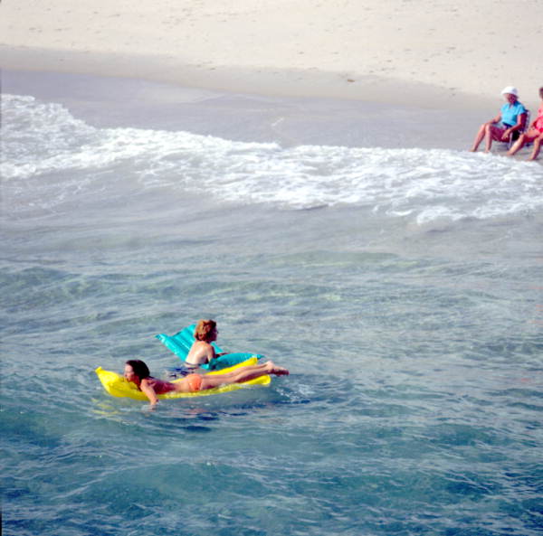 Young women on inflatable rafts enjoying the water - Lake Worth, Florida