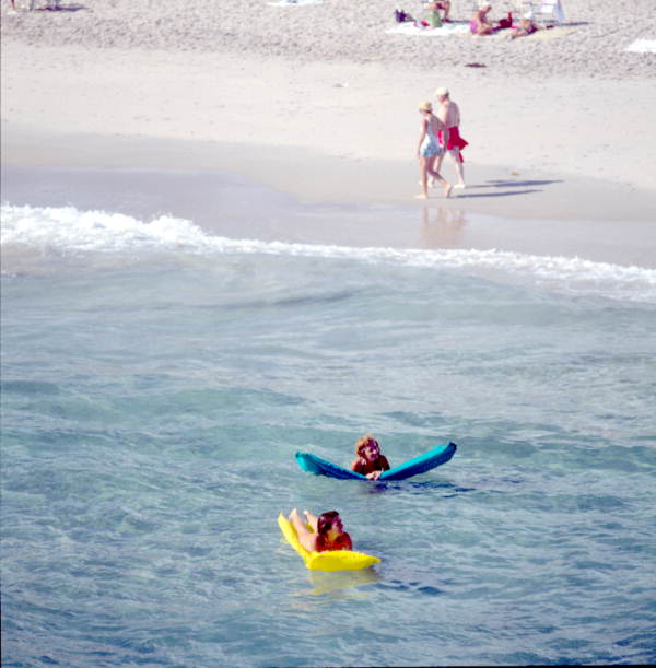 Young women on inflatable rafts enjoying the water - Lake Worth, Florida