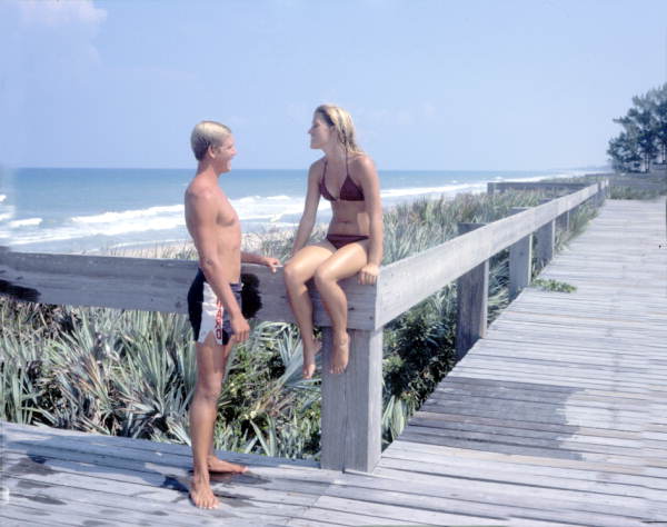 Young couple on the boardwalk by the sea - Melbourne Beach, Florida