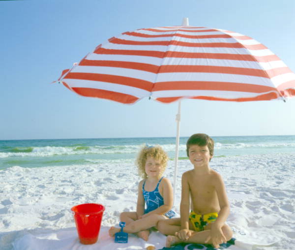 Children at the beach under an umbrella - Fort Walton Beach, Florida