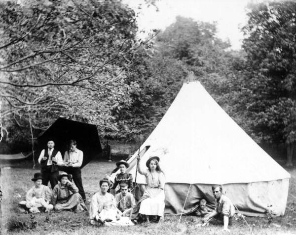 Lounging on the ground outside a tent