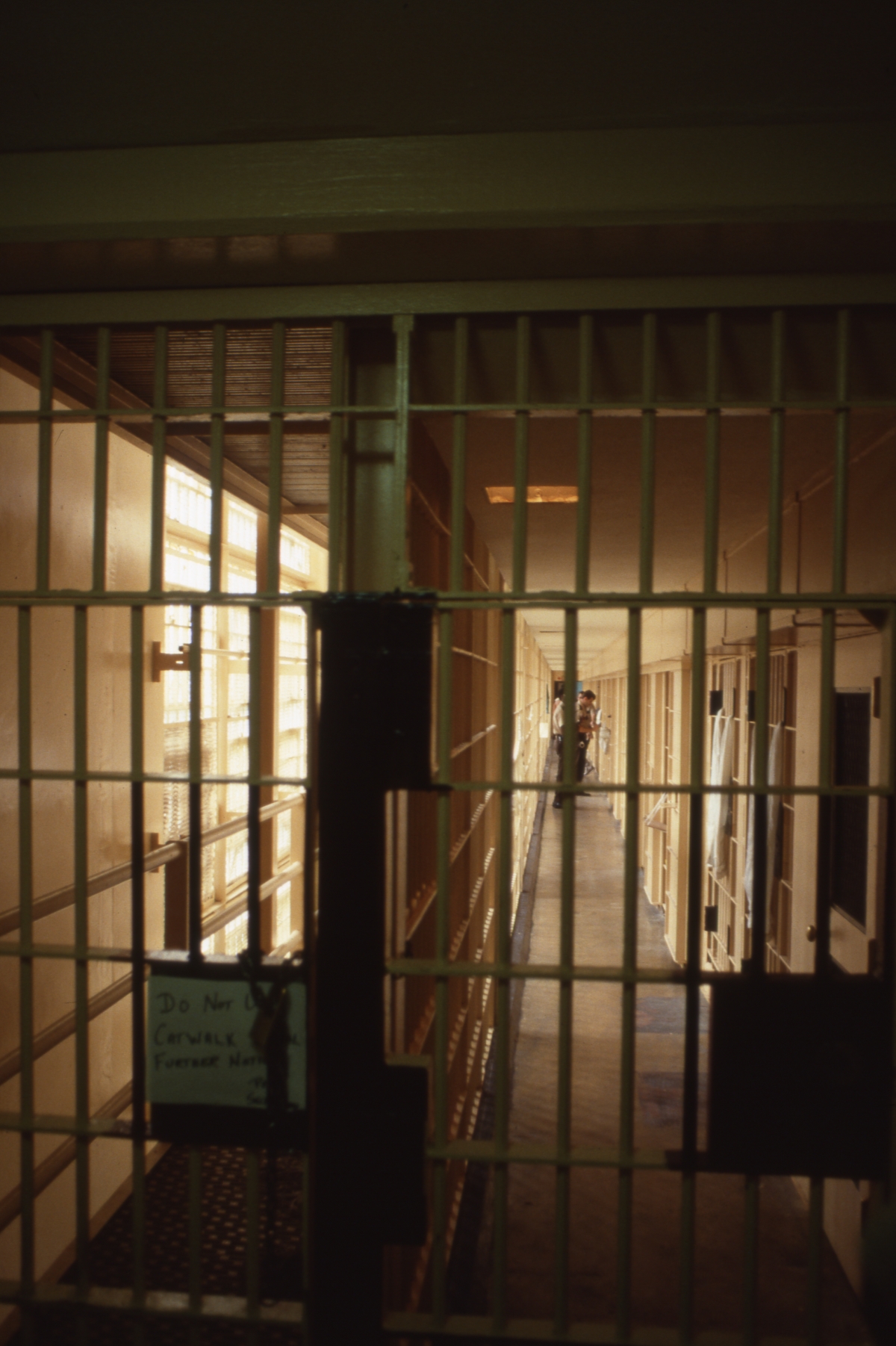 Florida Memory • Scene looking through the prison bars at guards in a ...