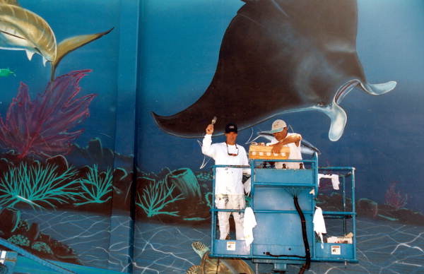 Internationally recognized artist "Wyland", at the left, during work on his mural.