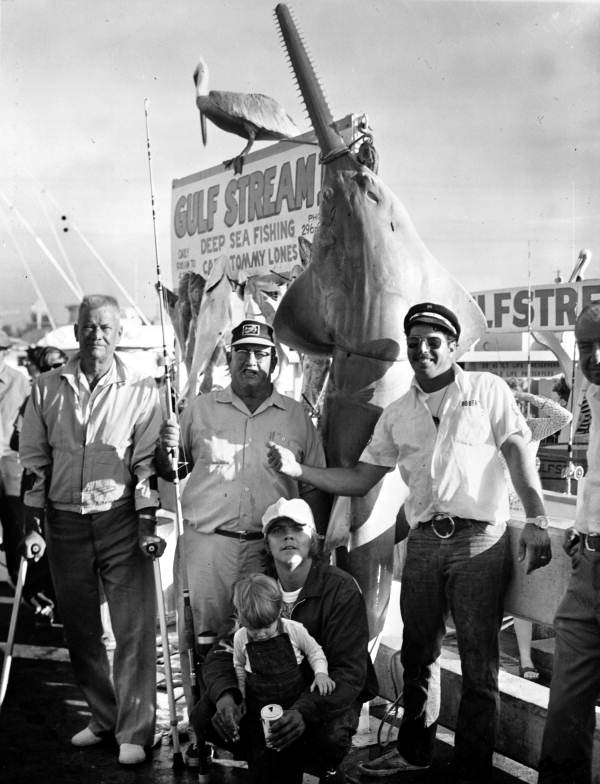 Group gathered in front of sawfish - Key West, Florida.