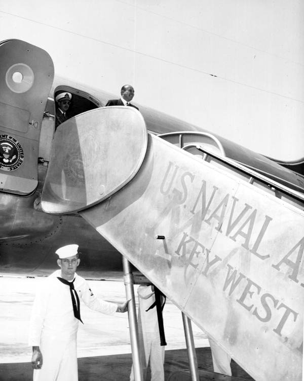 Chilean president Gabriel G. Videla standing at the top of stairs prior to boarding for flight to Washington D.C. - Key West, Florida