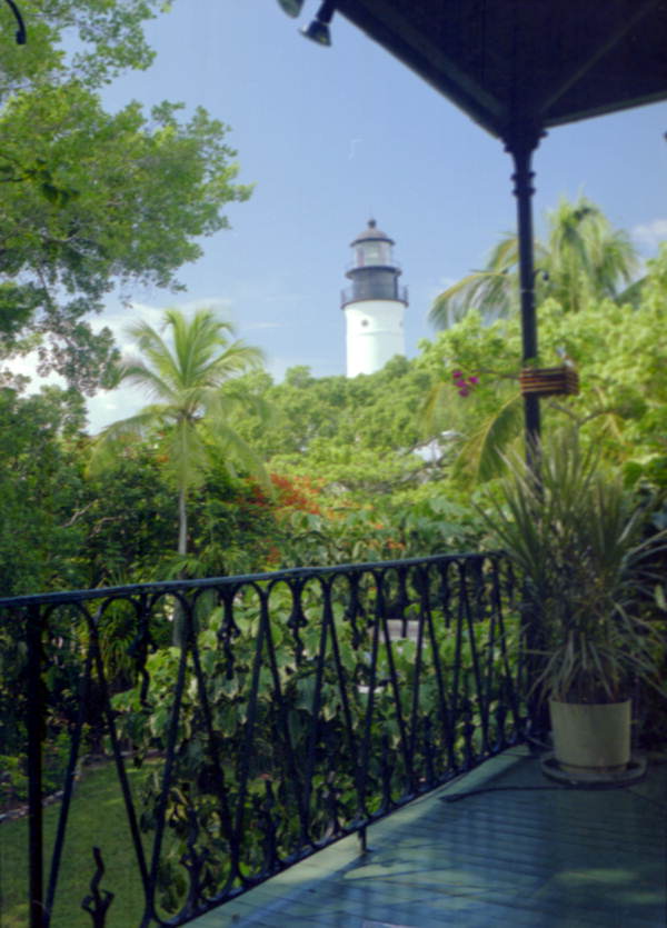 Looking towards the Key West Lighthouse from the 2nd floor of the Ernest Hemingway house museum - Key West, Florida.