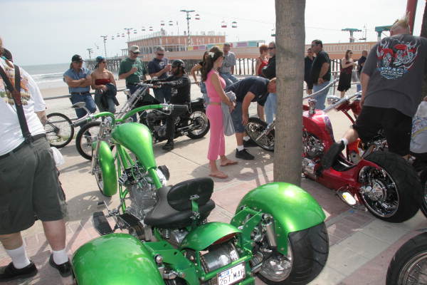People admiring motorcycles on display during the Boardwalk Chopper and Custom Bike Show - Daytona Beach, Florida.