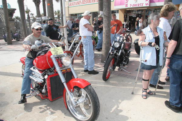 Man riding his motorcycle on boardwalk during custom bike show - Daytona Beach, Florida.