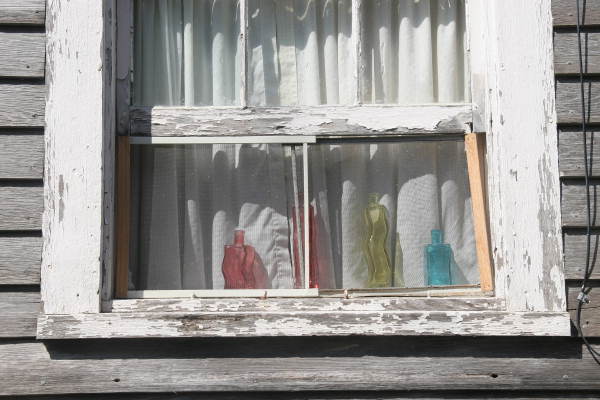 Colorful decanters in window on Love Lane - Key West, Florida