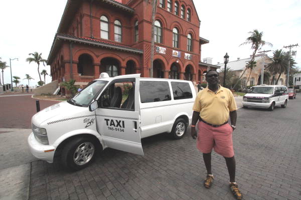 Al Rahming posing with his taxi for a portrait in front of the old customs building - Key West, Florida.
