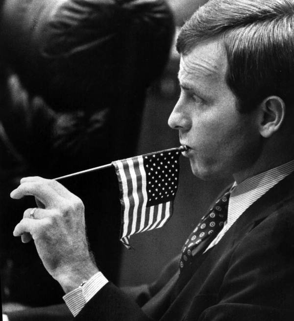 Rep. John Lewis, D-Jacksonville chews on the pole of a tiny American Flag - Tallahassee, Florida.