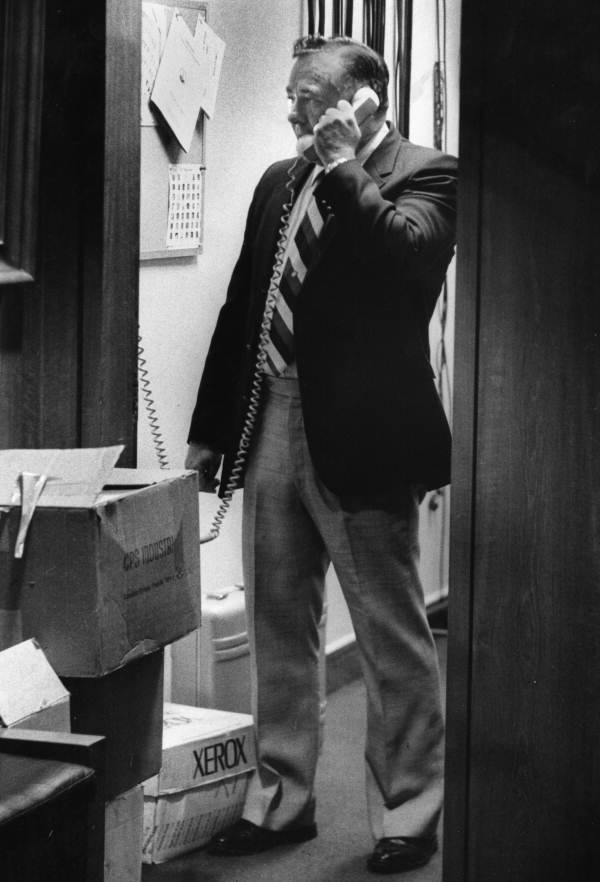 Rep. Spud Clemente uses the phone in a utility closet - Tallahassee, Florida.