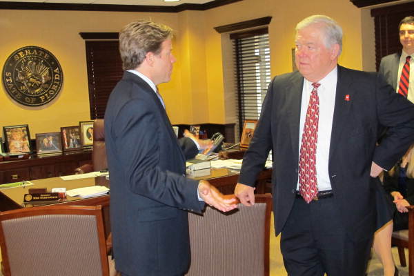 Florida Senate President Mike Haridopolos, left, speaking with Mississippi Governor Haley Barbour in his office at the state Capitol in Tallahassee, Florida.