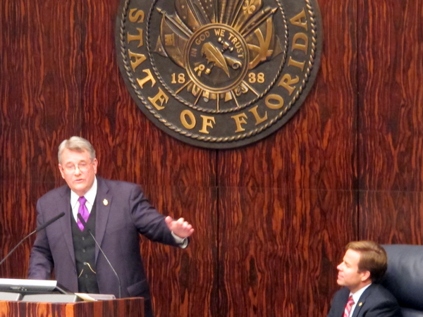 Senate President Mike Haridopolos watching Senator Don Gaetz speaking in the chamber.