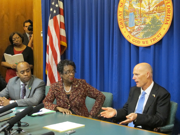 Governor Rick Scott, right, meeting with members from Florida's Legislative Black Caucus.