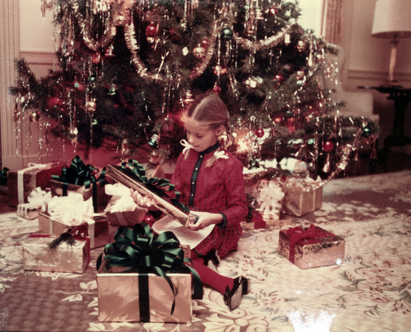 Governor's stepdaughter Adriana Dolabella by the tree in the mansion with Christmas presents.