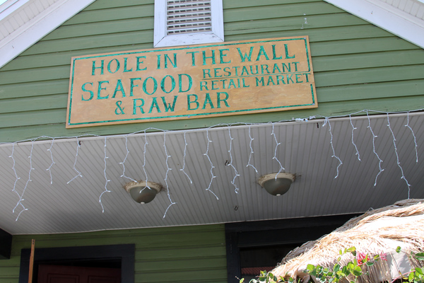 Close-up view of Hole in the Wall Seafood restaurant & raw bar at 23 Ave. D in the Apalachicola Historic District.