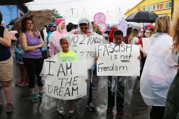 People holding up their signs at Railroad Square during the 2017 Women's March in Tallahassee.