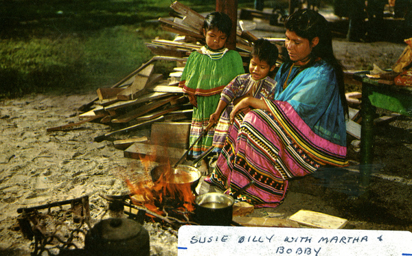 Seminole cooking over open wood fire in Florida Everglades.