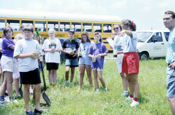View of children taking part in a summer program to plant mangroves - Merritt Island, Florida
