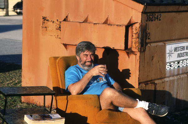 Portrait of photographer David LaHart drinking next to a dumpster at a solid waste disposal facility - Brevard County, Florida