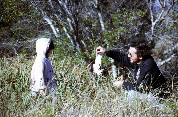 Three year old Marcy LaHart looking at bird with Bob Cane