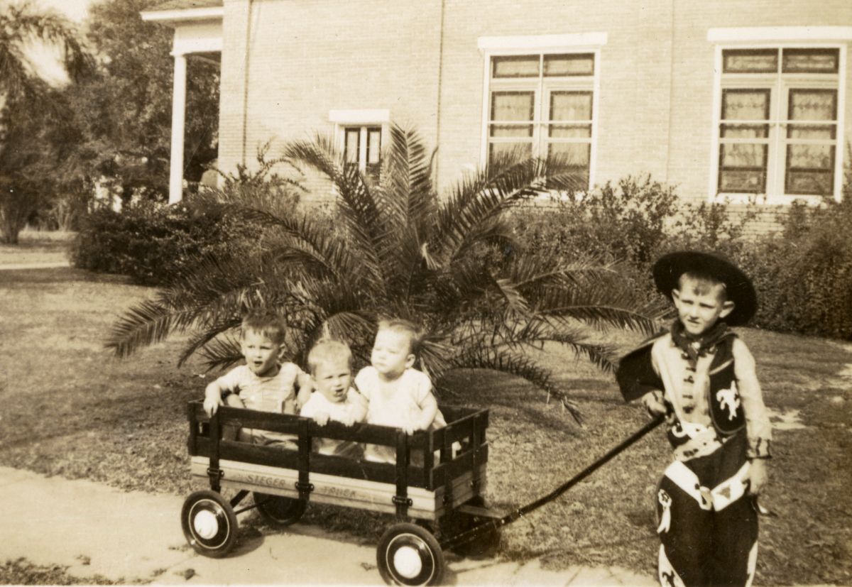 Ray Alley Jr. pulling wagon with brother and cousins in it during Christmas in Groveland, Florida.