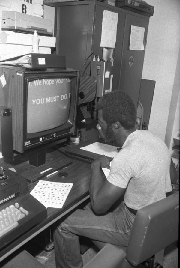 Unidentified man uses computers - Tallahassee, Florida.