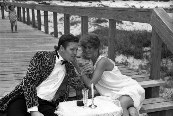Fashion models on the boardwalk at the beach.