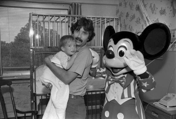 Mickey Mouse with unsure child and parent at a hospital - Tallahassee, Florida.